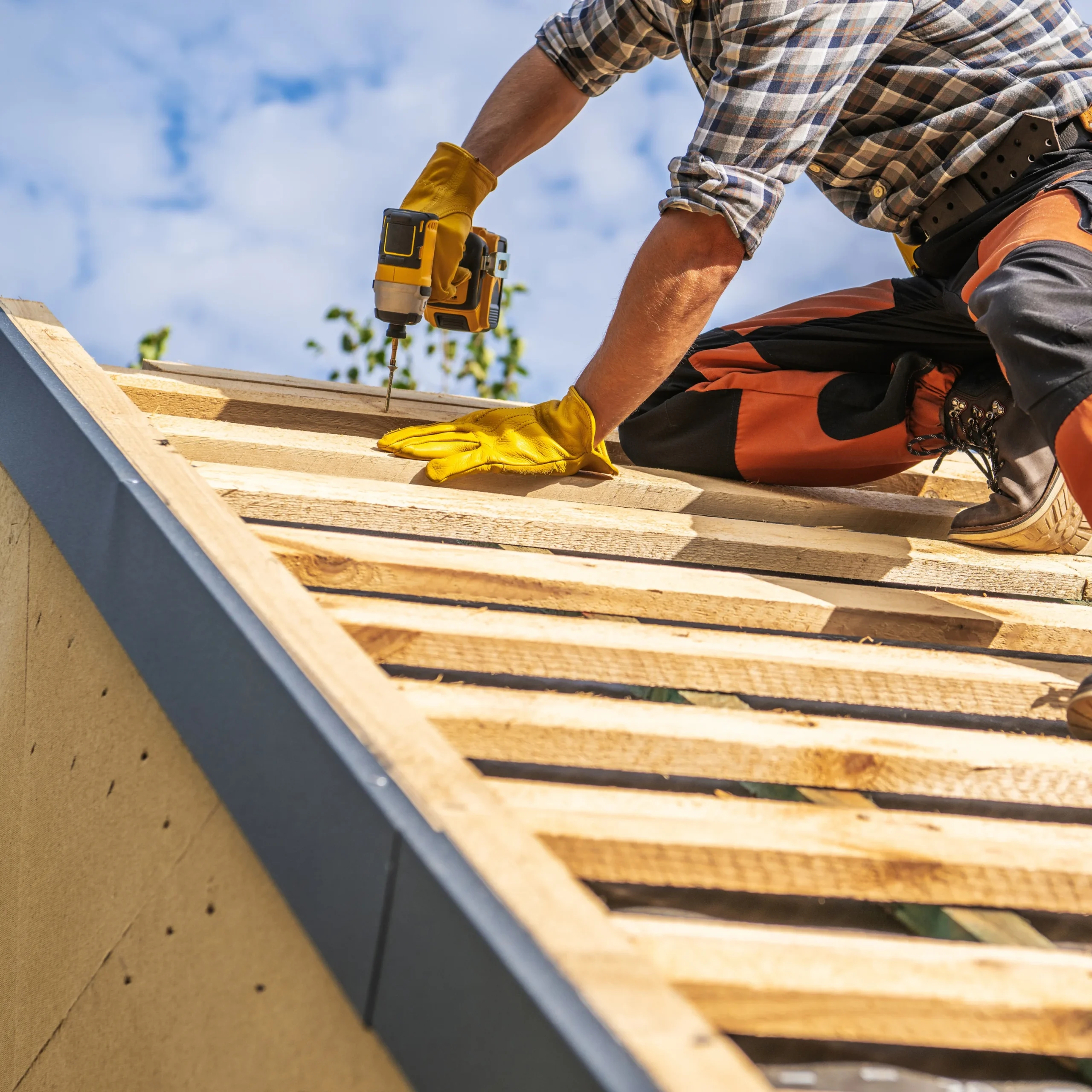 aperçu d'un artisan sur le toit d'un abri ou d'une maison en train de réaliser la charpente en bois
